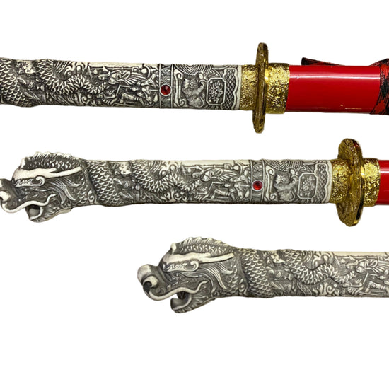 Two ornate swords with detailed dragon designs on a white background