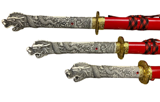 Two ornate swords with detailed dragon designs on a white background