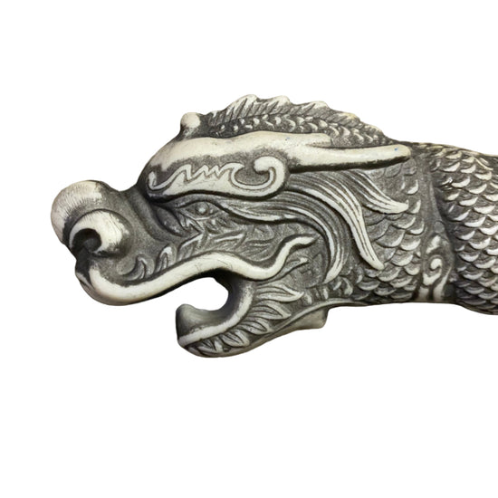 Decorative dragon head sculpture on a white background