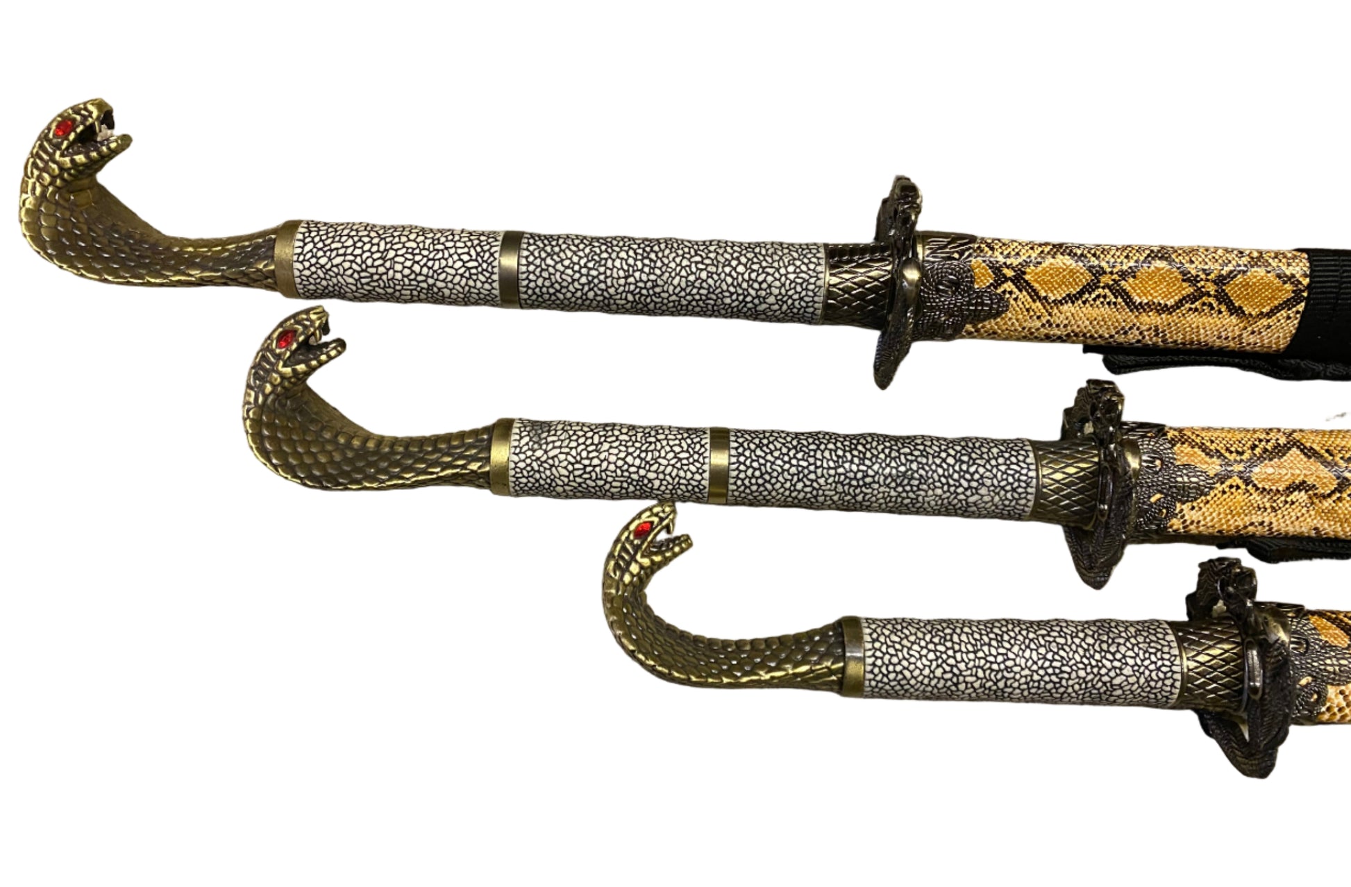 Three ornate swords with decorative sheaths on a white background