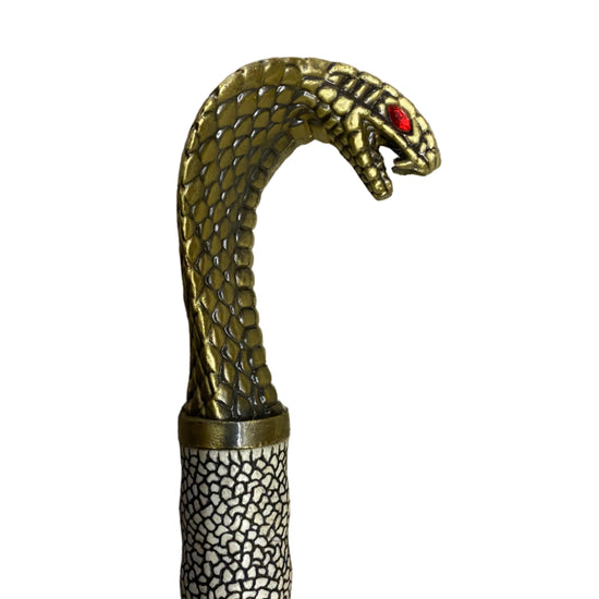 Decorative walking cane with snake head design on a white background
