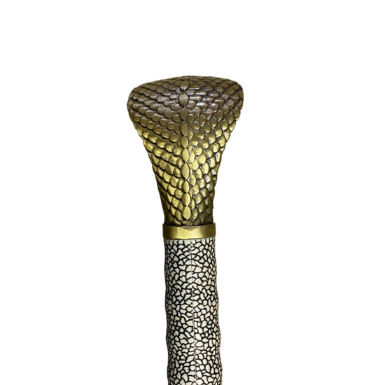 Decorative object with textured gold top and base on a white background