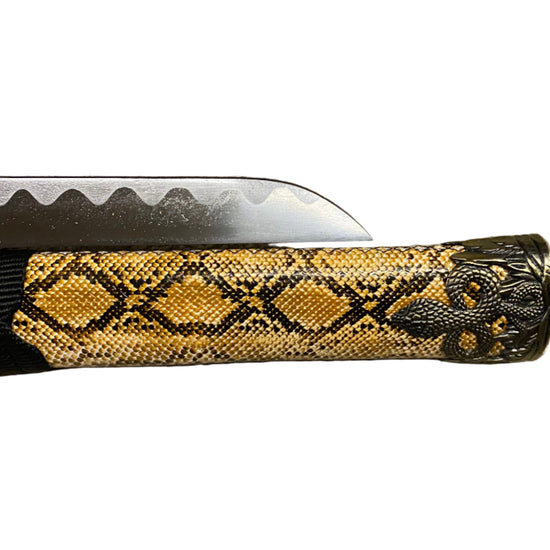 Folding knife with snake pattern handle on a white background