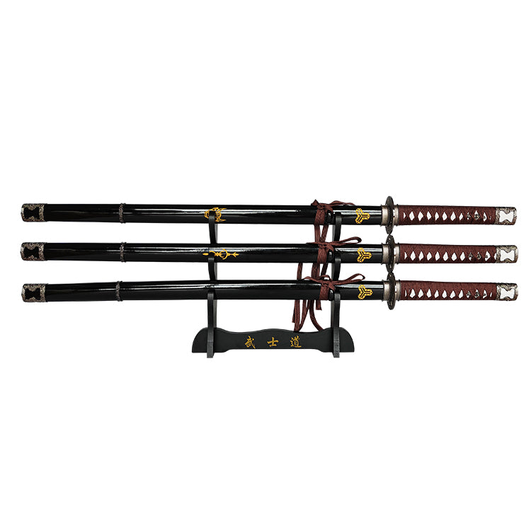 Set of three Japanese swords on a stand with decorative handles and sheaths.