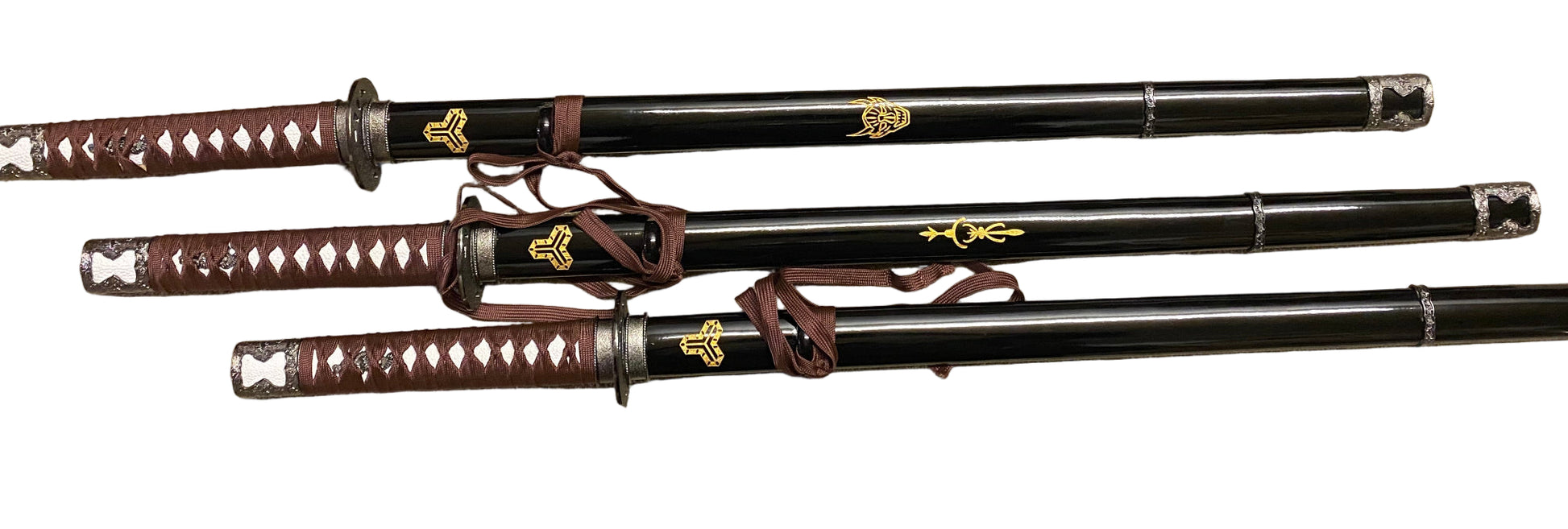 Three black samurai swords with brown sheaths on a white background