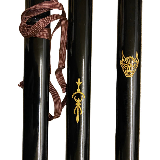 Three black swords with gold symbols on a white background