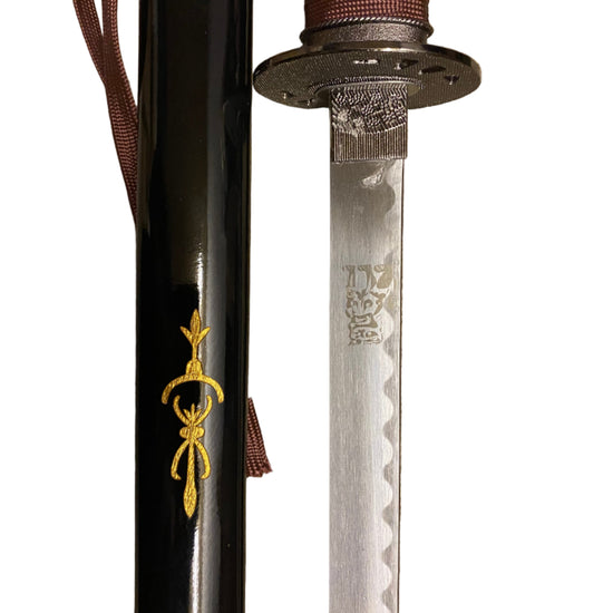 Sword with a black sheath and decorative elements on a white background