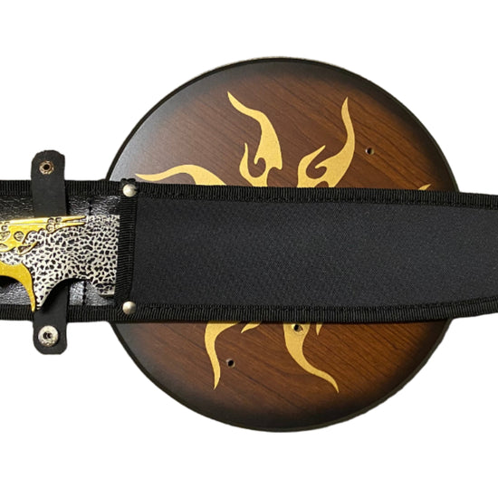 Decorative knife with black sheath and wooden handle on a white background