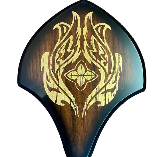 Wooden object with gold tribal design 