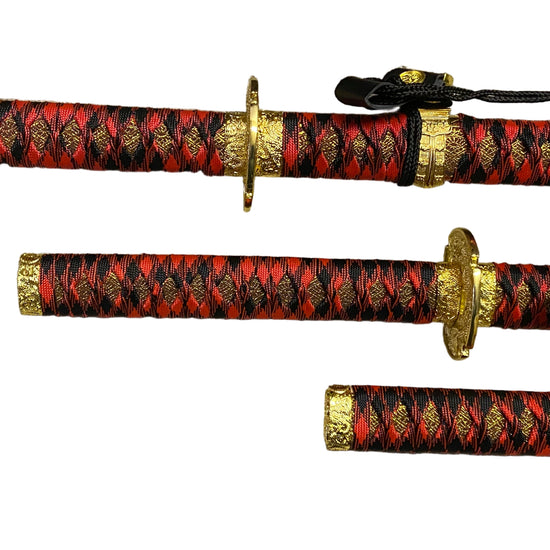 Three red and black patterned swords with gold accents on a white background