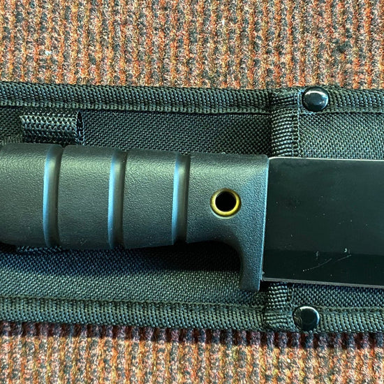 Knife with sheath on a textured surface