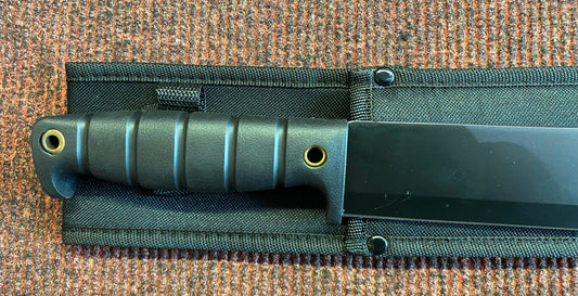Knife with sheath on a textured surface