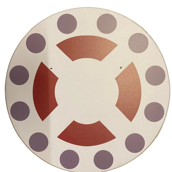 Decorative plate with purple polka dots and red geometric shapes on a beige background