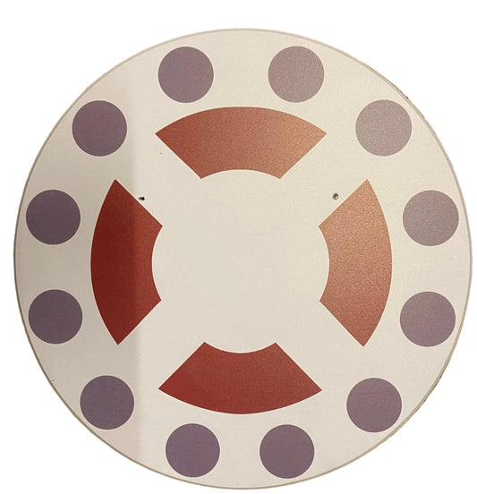 Decorative plate with purple polka dots and red geometric shapes on a beige background