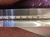 Metallic object with engraved text on a textured surface