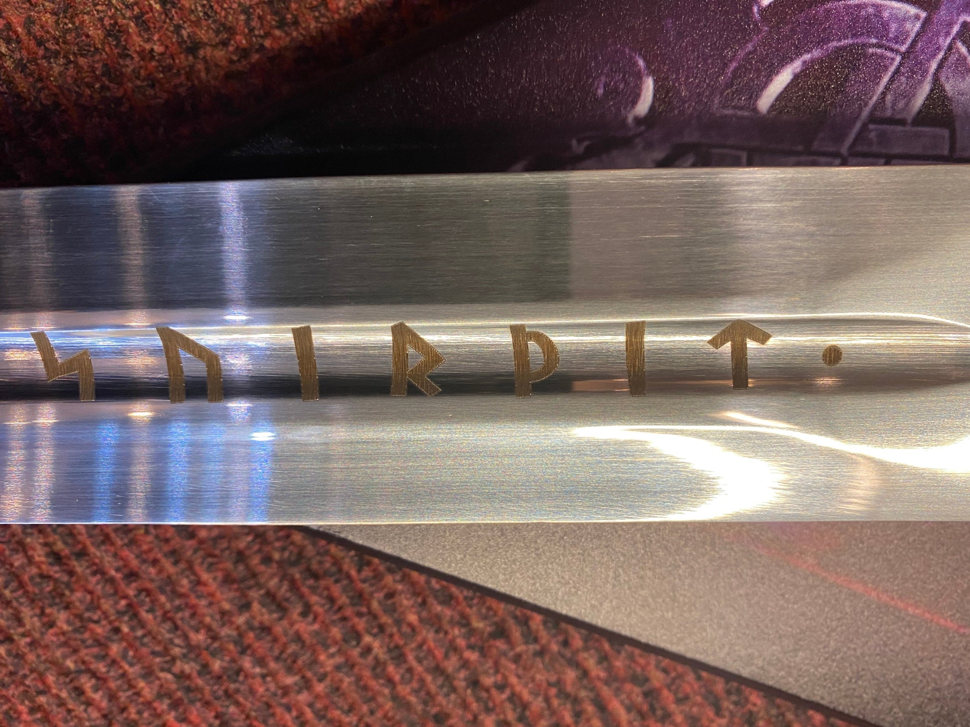 Metallic object with engraved text on a textured surface