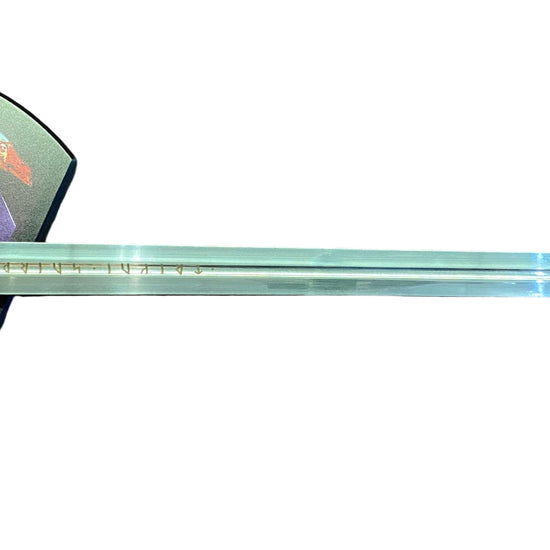 Long sword with decorative sheath on a brown surface