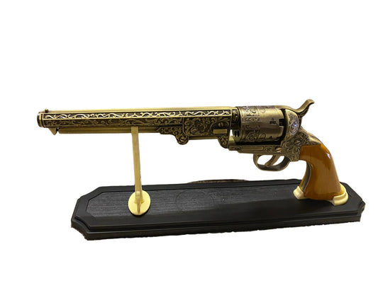 Decorative revolver on a stand with a white background