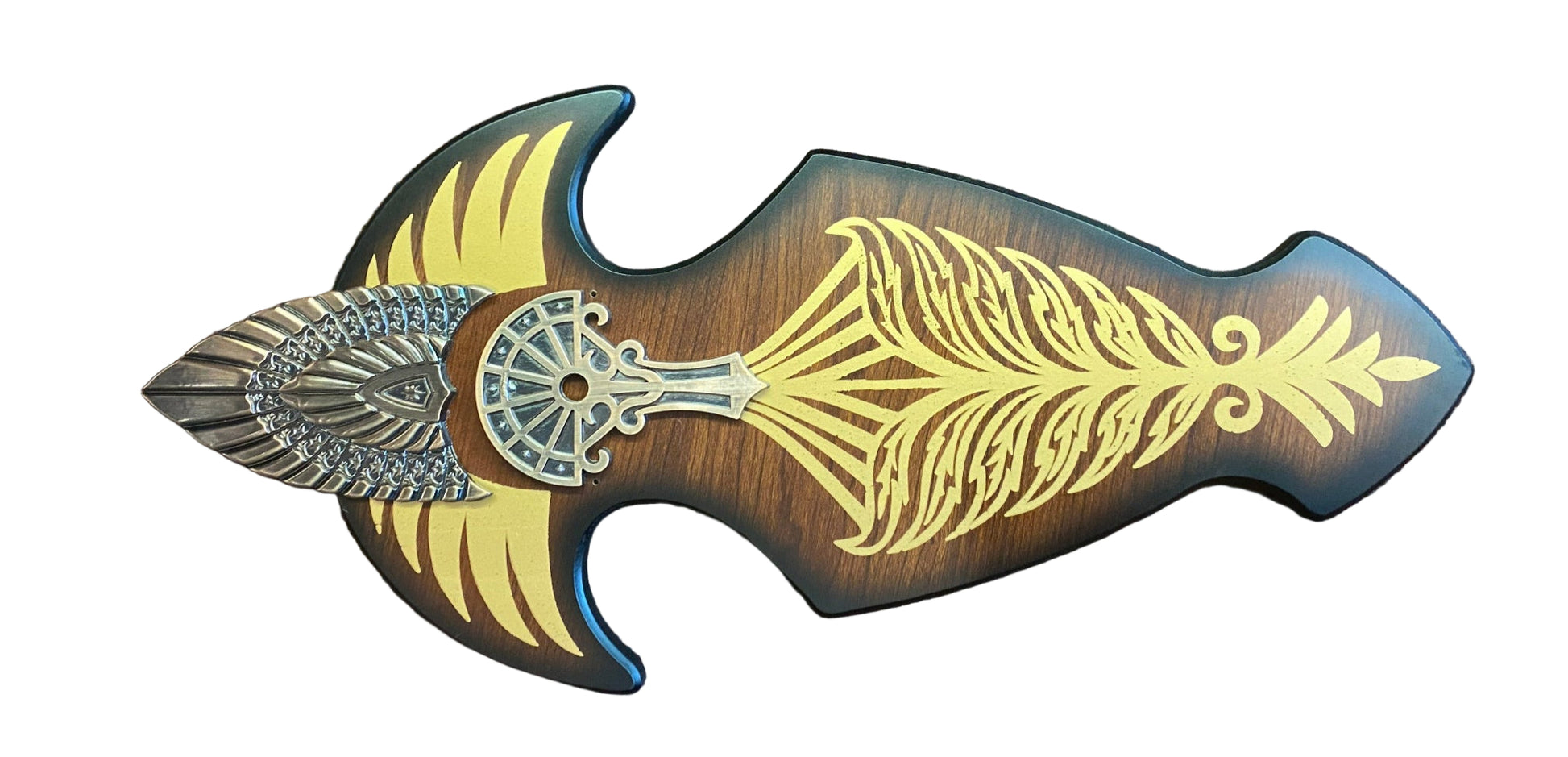 Decorative weapon with gold and silver designs on a brown textured background