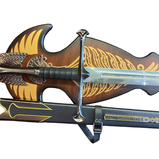 Decorative sword with ornate handle and sheath on a textured surface