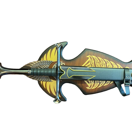 Decorative sword with gold and black design on a brown textured background