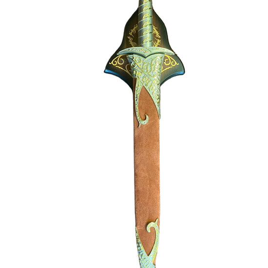 Decorative sword with ornate handle on a textured surface