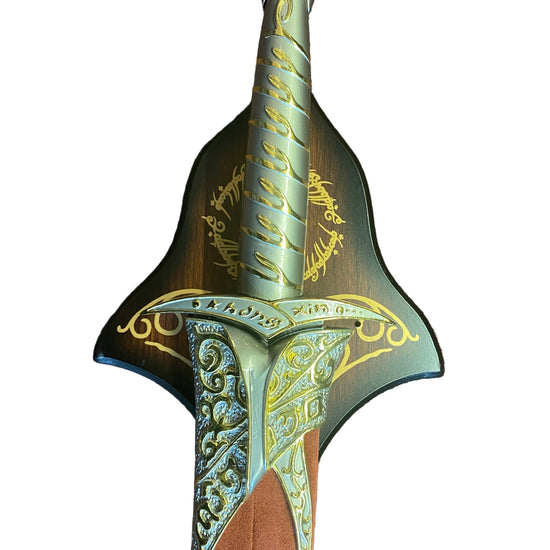 Decorative sword with intricate gold patterns on a brown textured background