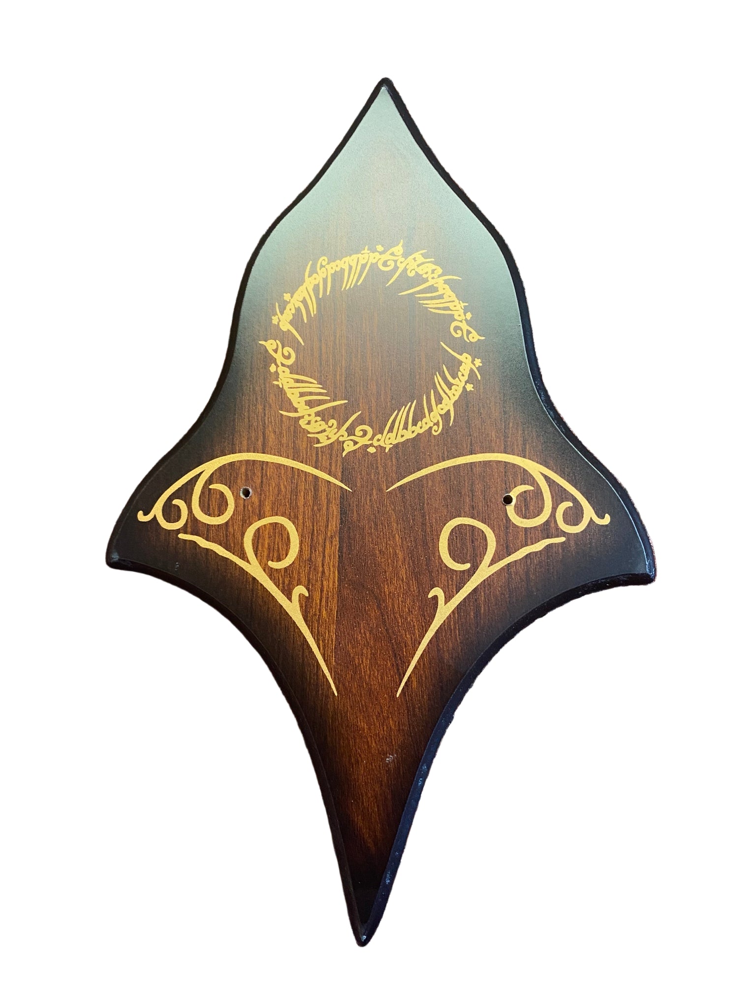 Wooden guitar pickguard with engraved text on a brown textured surface