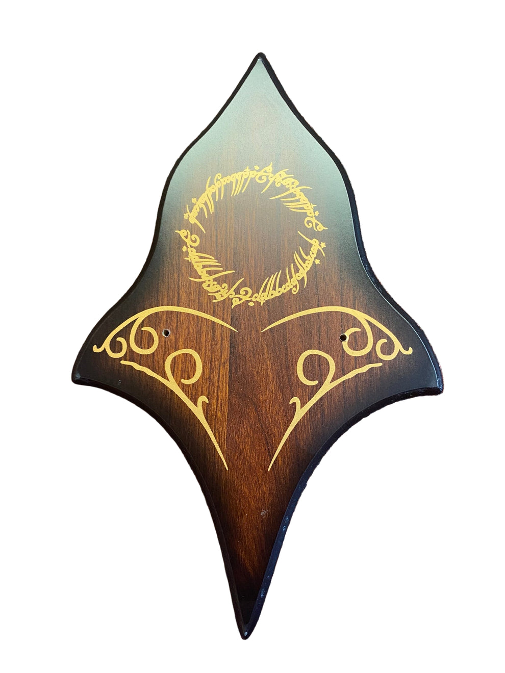 Wooden guitar pickguard with engraved text on a brown textured surface