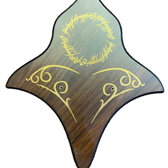 Wooden plaque with engraved text on a textured surface