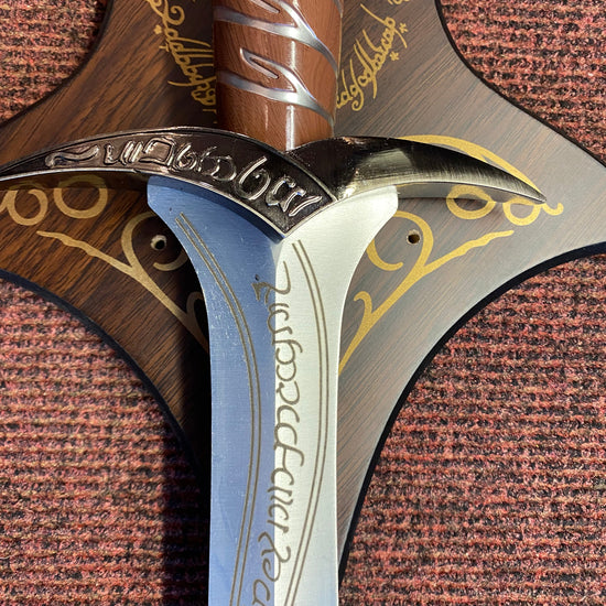 Close-up of a sword with ornate handle and blade on a textured brown background