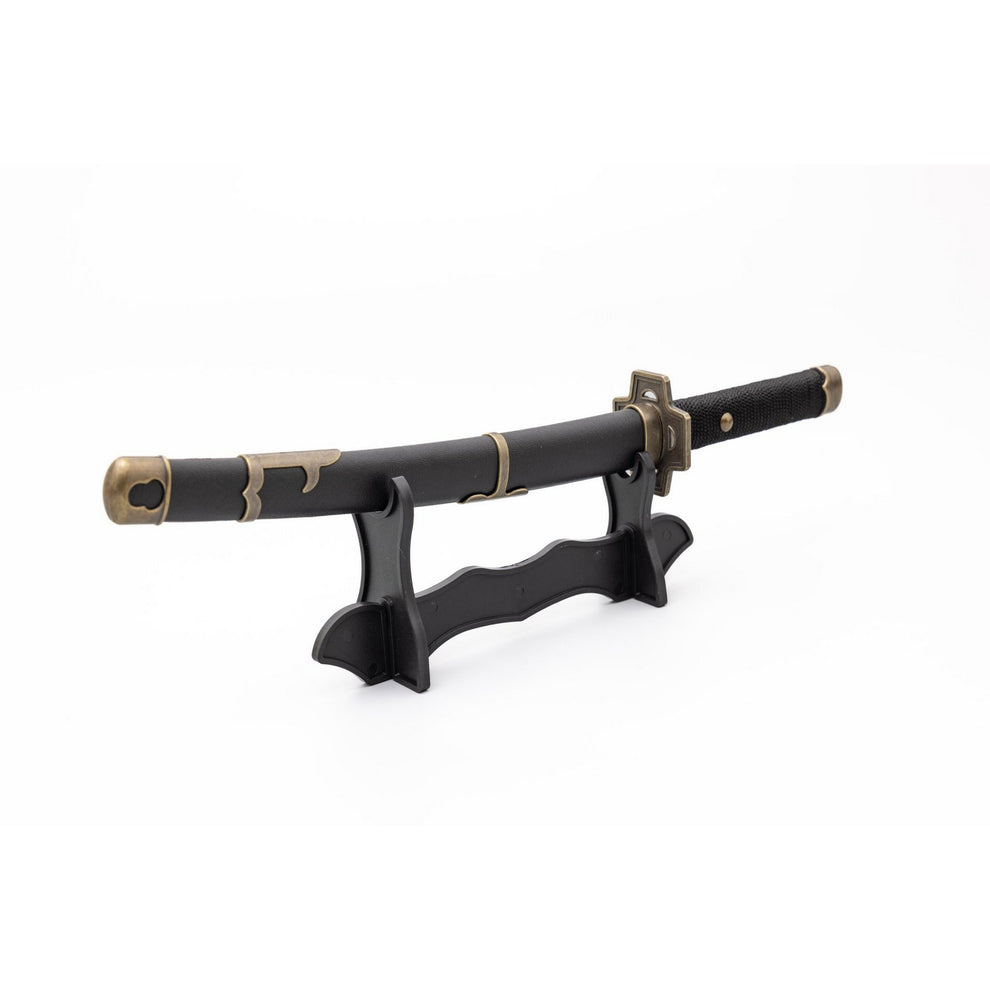 Black sword with gold accents on a stand against a white background