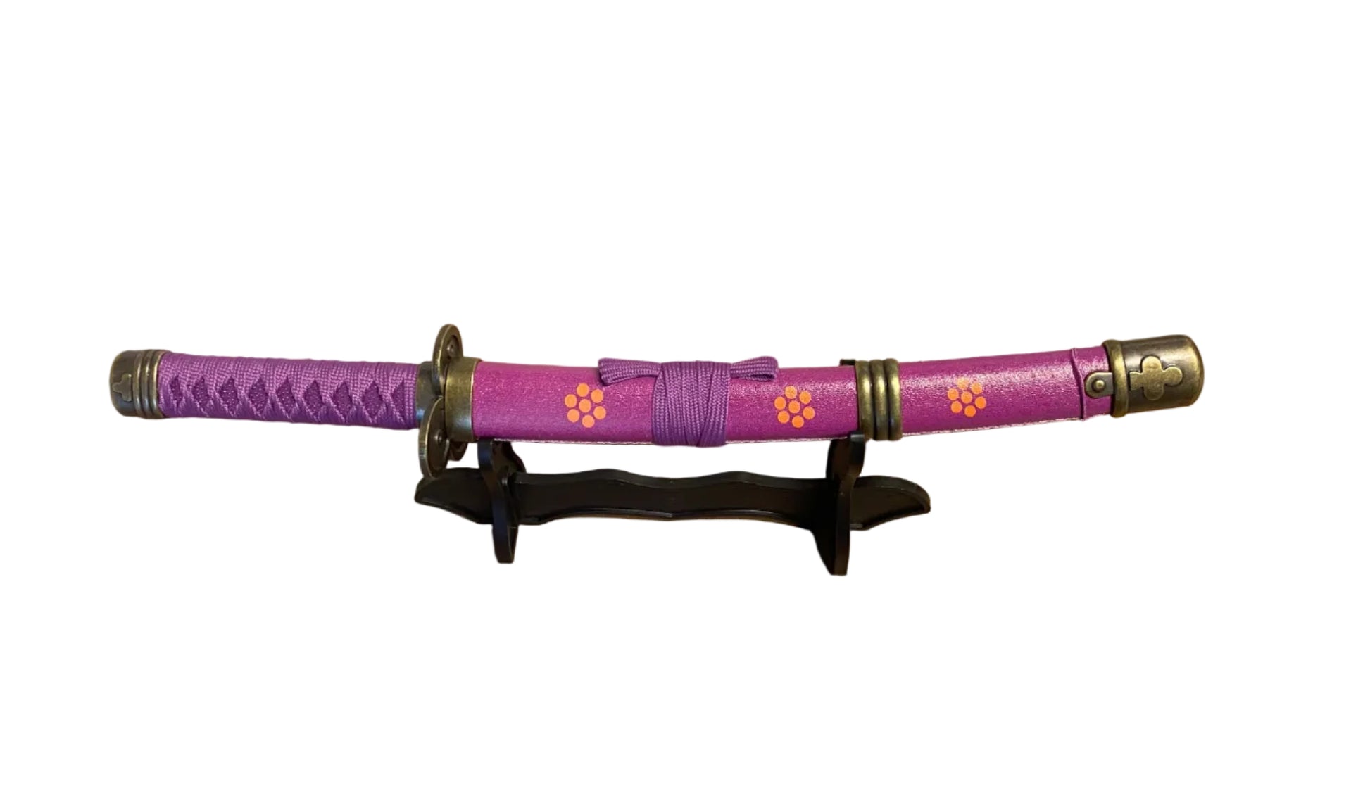 Purple  sword with decorative elements on a stand against a plain background