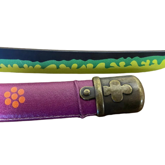 Purple folding knife with floral design on a brown surface