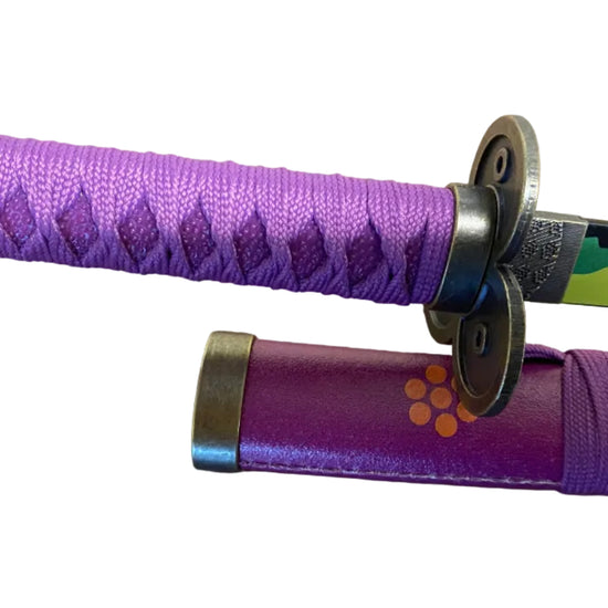 Purple sword handle with decorative patterns on a brown background