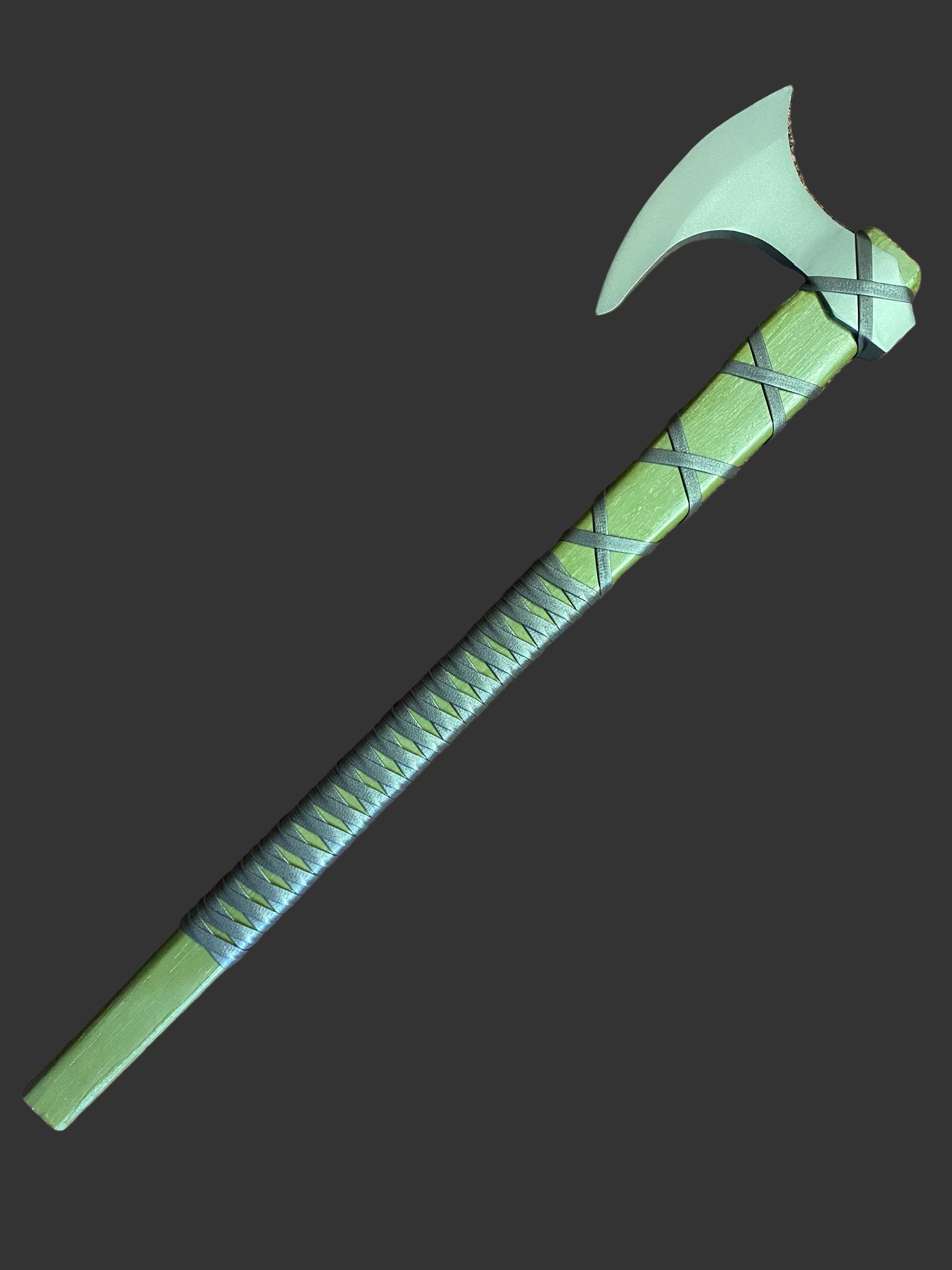 Green axe with a textured handle on a brown surface