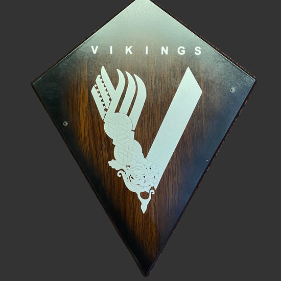 Decorative plaque with 'Vikings' logo on a textured brown background