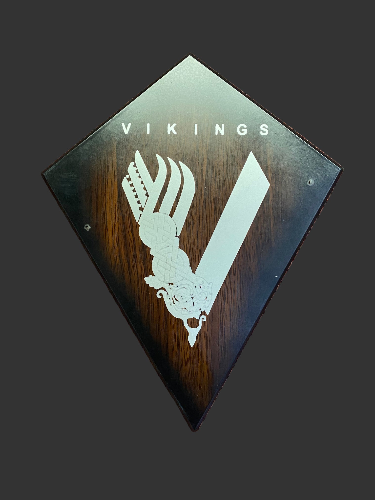 Decorative plaque with 'Vikings' logo on a textured brown background