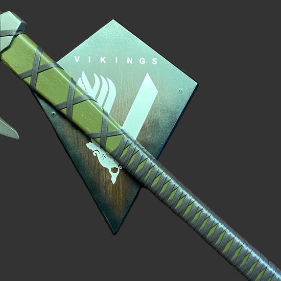 Green axe with a sheath on a brown textured surface