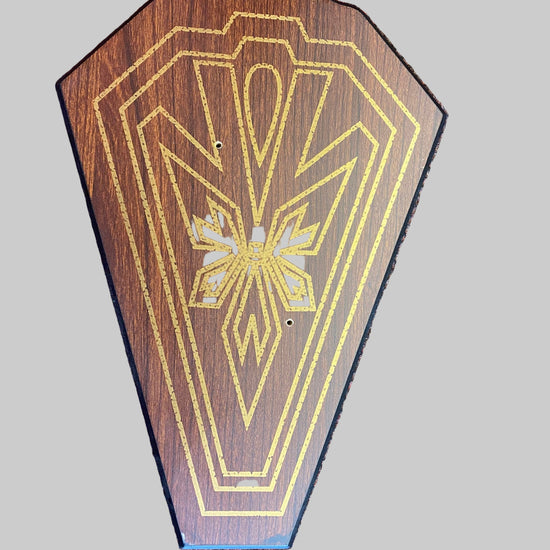 Wooden plaque with geometric design on a textured surface