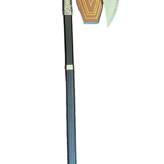 Decorative axe with a geometric head on a textured surface