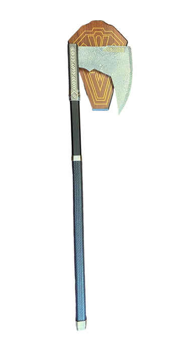 Decorative axe with a geometric head on a textured surface