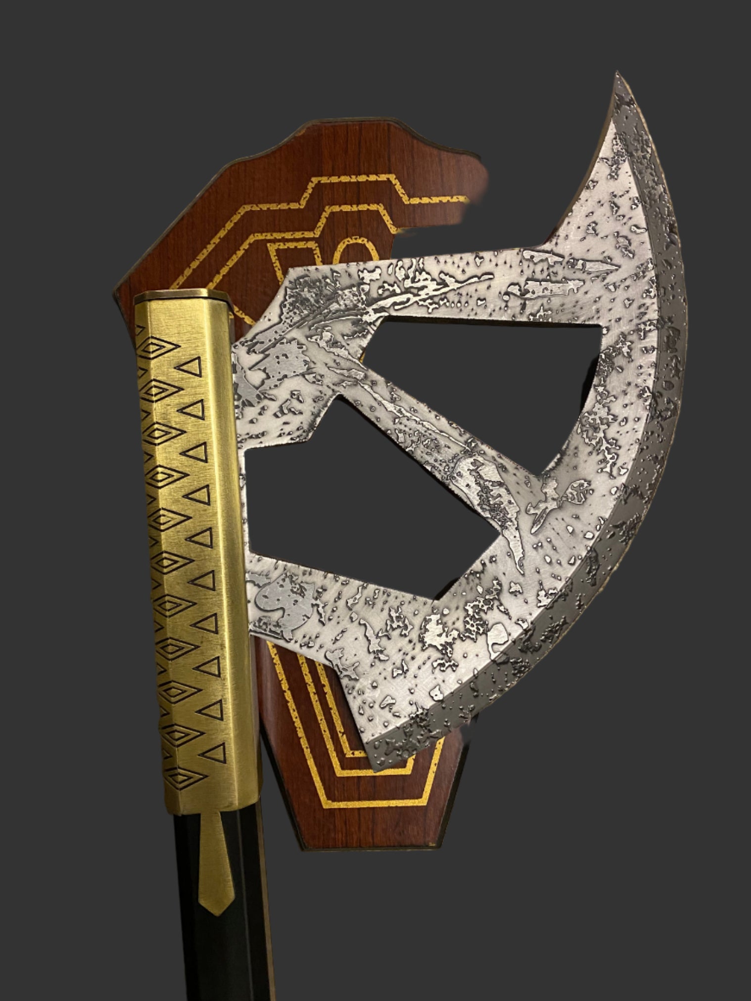 Decorative axe with wooden handle and metallic blade on a dark background