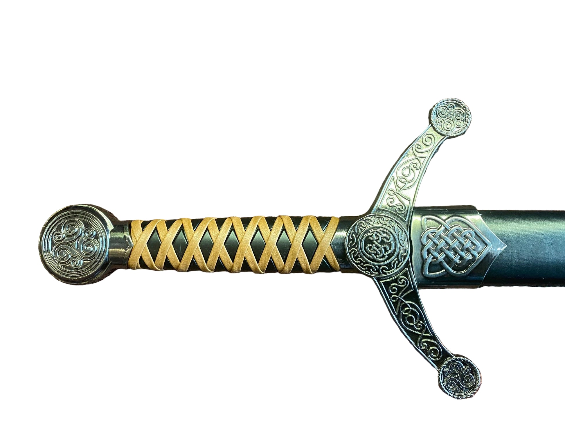 Decorative sword handle with intricate designs on a textured surface