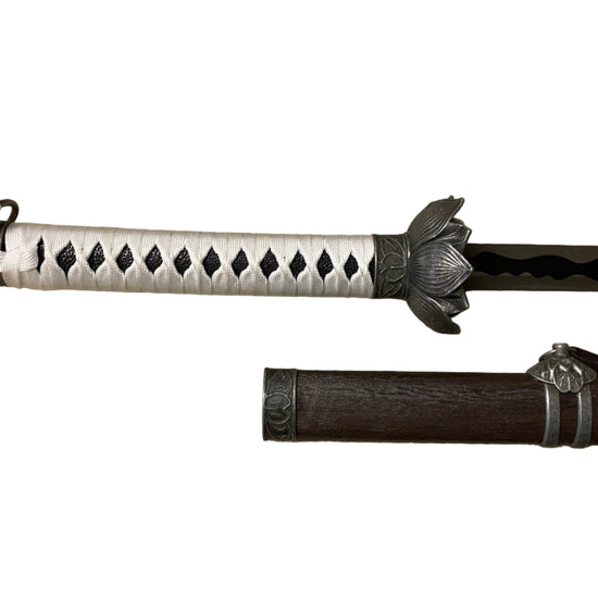 Sword with decorative sheath on a white background