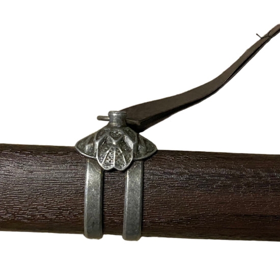 Close-up of a crossbow bolt with a metallic nock on a white background