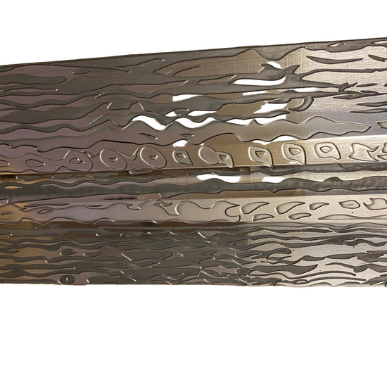 Metallic object with intricate patterns on a textured surface