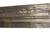 Metallic object with intricate patterns on a textured surface