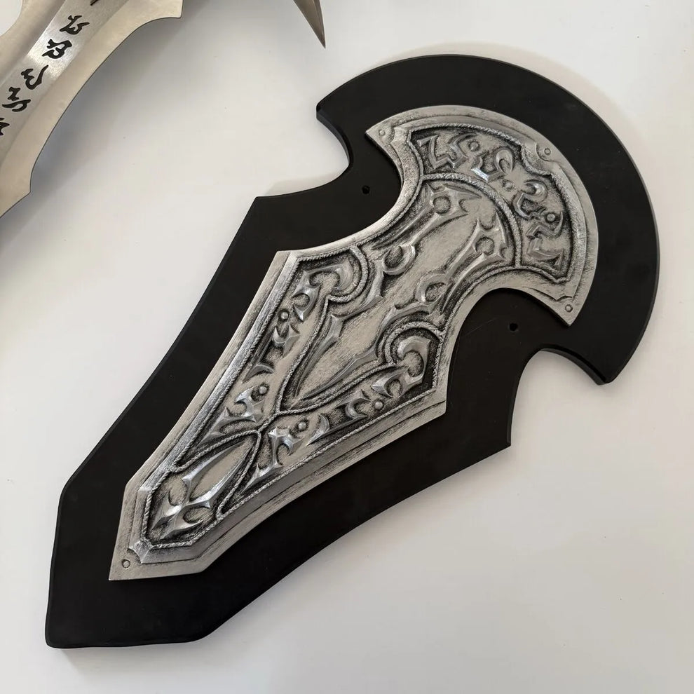 Decorative sheath with intricate silver design on a white background