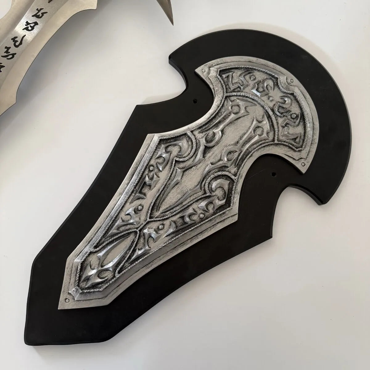 Decorative sheath with intricate silver design on a white background